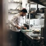 Chef working in a commercial restaurant kitchen during service