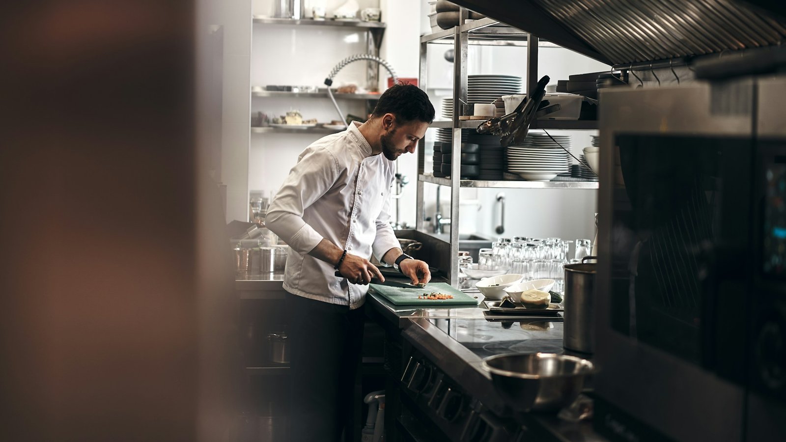 Chef working in a commercial restaurant kitchen during service