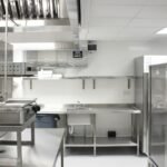 Professional commercial kitchen with stainless steel equipment and storage