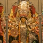 Durga idol with ornate decorations and flower garlands at Chhatu Babu Latu Babu Thakur Bari in Kolkata