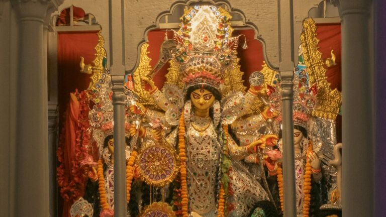 Durga idol with ornate decorations and flower garlands at Chhatu Babu Latu Babu Thakur Bari in Kolkata