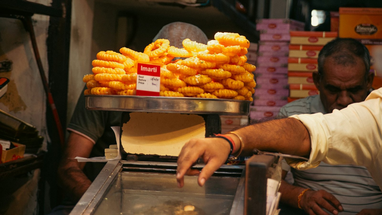 Imarti displayed on a tray at an Indian sweet-shop counter; illustrative scene