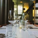 Set restaurant dining table with glasses and place settings