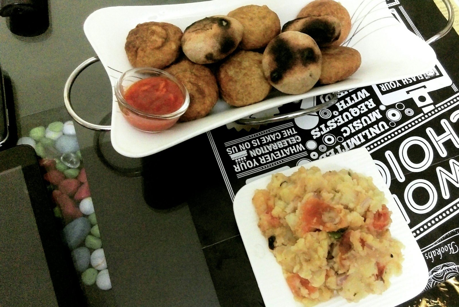 Litti served with vegetable chokha and accompaniments on a plate